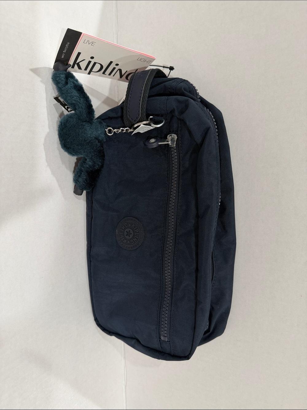 Kipling Men's Dark Navy Sling Belt Bag with Plush Monkey Charm